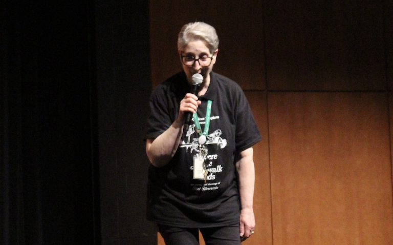 Theater teacher Danielle Trebus speaks to the audience at the matinee presentation of "Where the Sidewalk Ends" April 24.